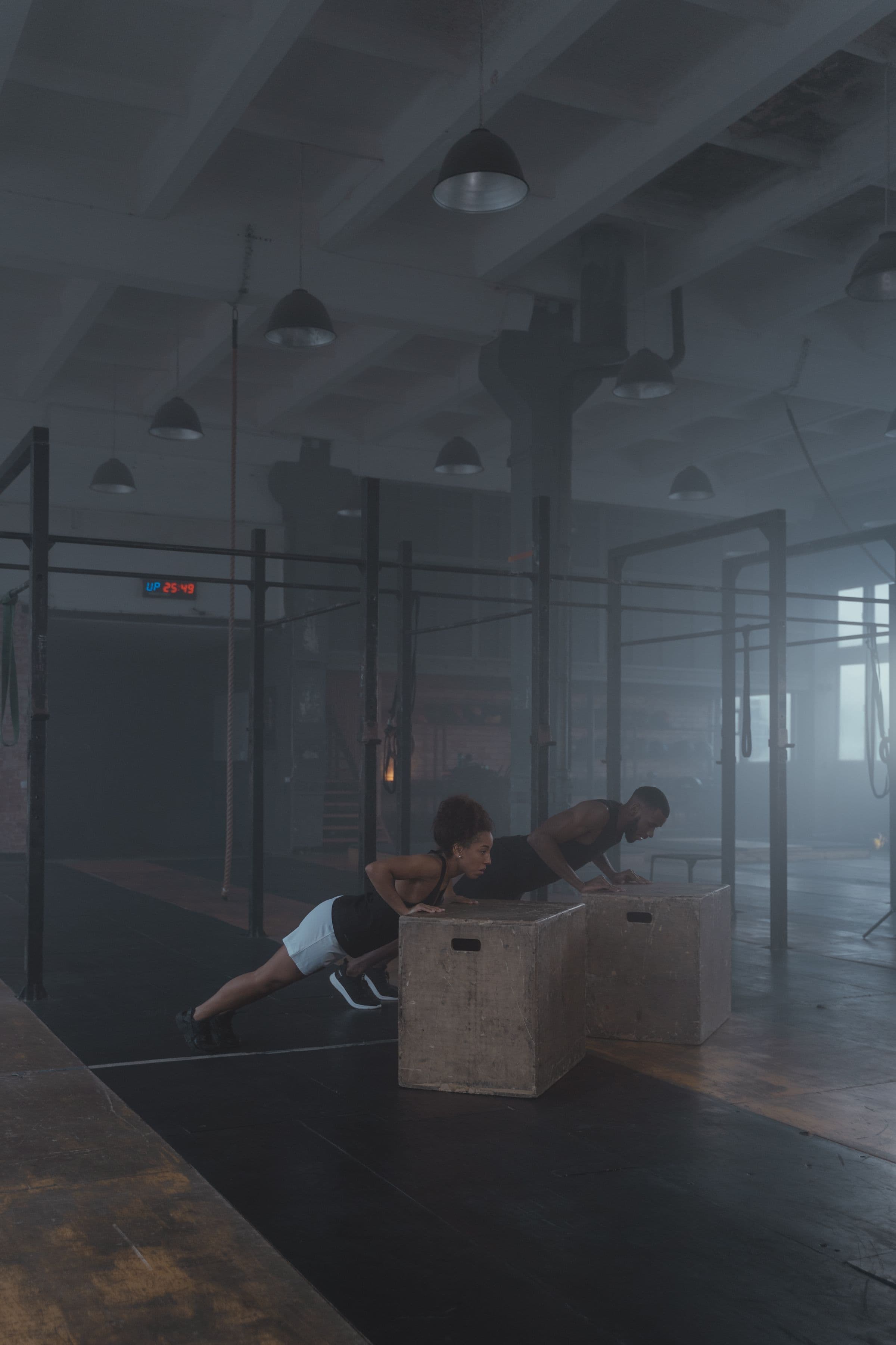 Two athletes completing a strength exercise in the same training space